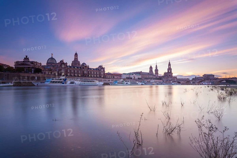 14 October 2021, the historic skyline along the Elbe River stands against a colorful twilight sky in Dresden, Saxony, Germany