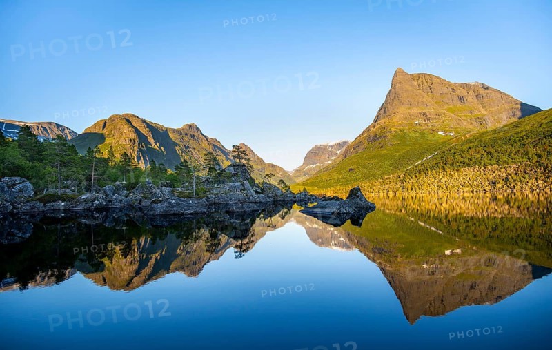 Picturesque mountain landscape with Innerdalstårnet peak in Innerdalen high valley, mountain peaks reflected in Lake Innerdalsvatna, Trollheimen Mountain Area, Sunndal, Møre og Romsdal, Norway