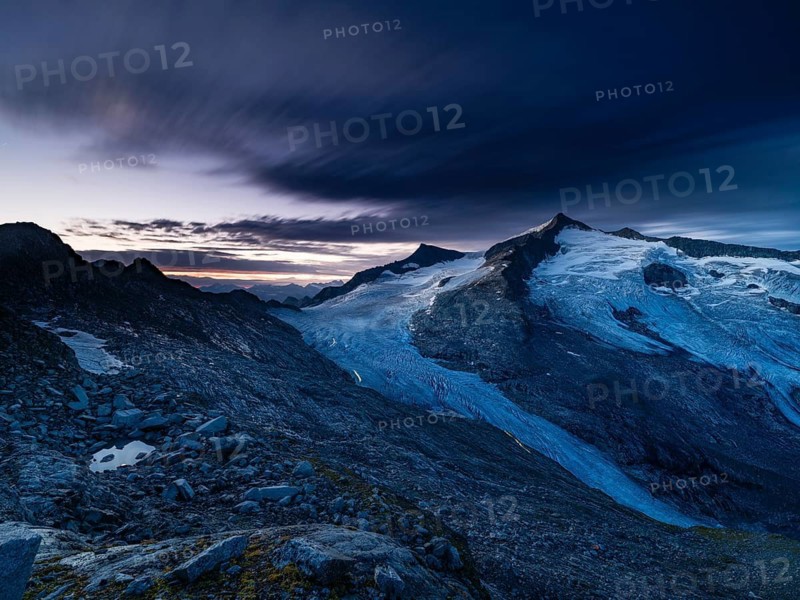 Glaciated summit of Grossvenediger, at dawn, on the Venedigerkees Traces of light from mountaineers, Venice Group, Hohe Tauern National Park, Province of Salzburg, Austria
