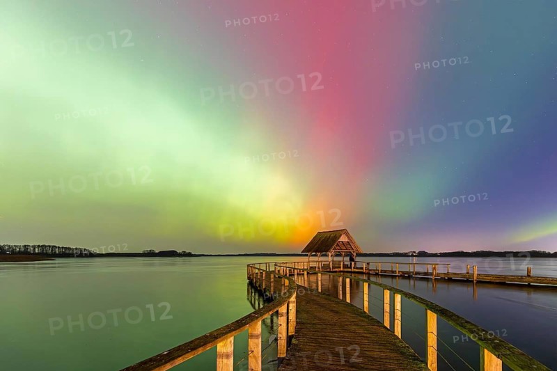 Wooden jetty and Northern Lights, Aurora borealis, polar lights over Lake Hemmelsdorf, Hemmelsdorfer See near Lübeck, Schleswig-Holstein, Germany