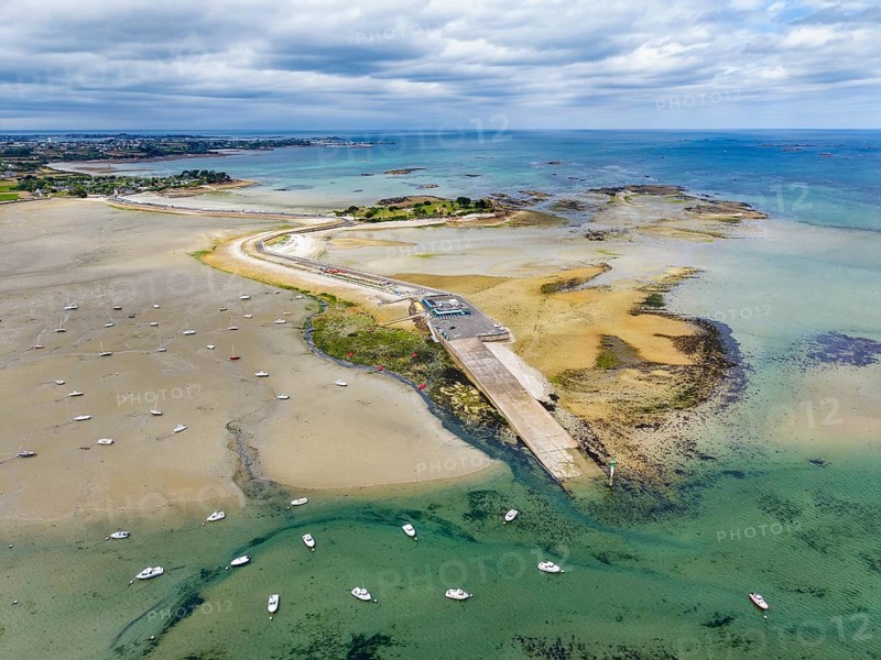 Aerial view of the peninsula, Îlot Sainte-Anne and the surrounding Wadden Sea landscape on the Breton coast with shallow sandbanks in turquoise seawater, Saint-Pol-de-Léon, Finistère, Brittany, France