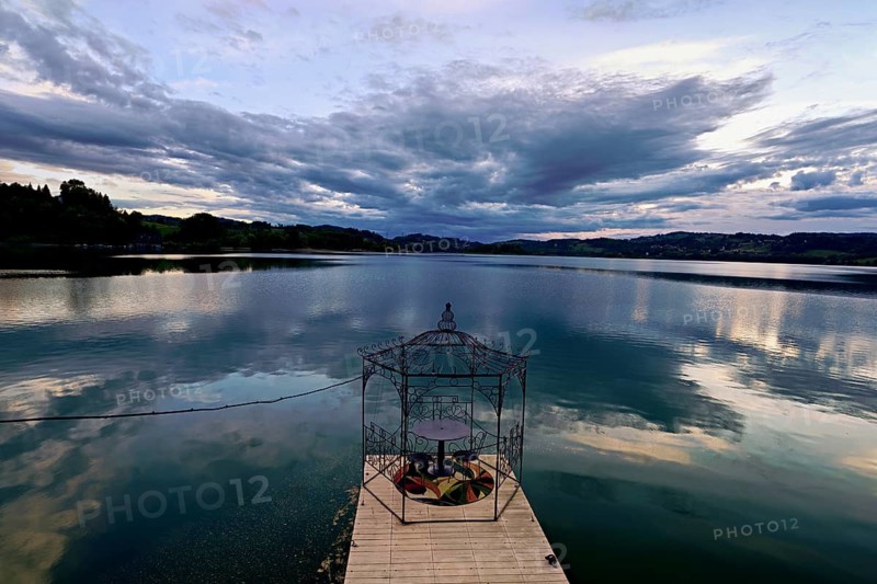 Table with two chairs on a pier at Lac d'Aiguebelette, Great Natural Lake, Aiguebelette-le-Lac, Savoie Department, France