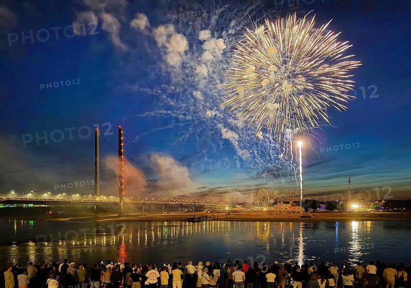 Rhine fair with Rheinkniebrücke, many people watch the fireworks at night, Düsseldorf, North Rhine-Westphalia, Germany