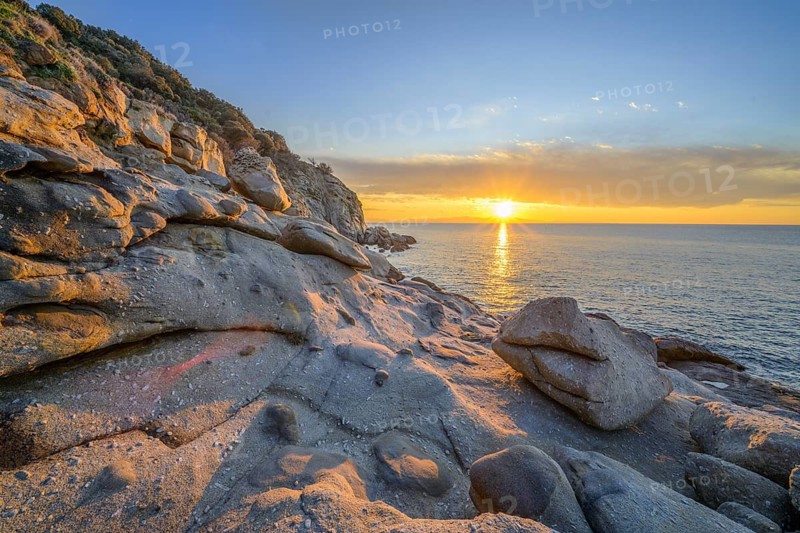 Rock formations in the evening light on, Capo Sant Andrea, Marciana, Livorno Province, Italy