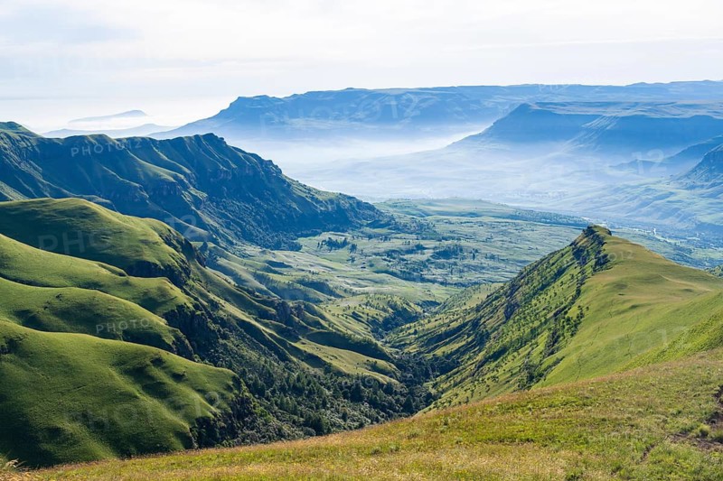 Panorama, green fields and mountains, mountain landscape of the Cathedral Range, Drakensberg Mountains, KwaZulu-Natal, South Africa