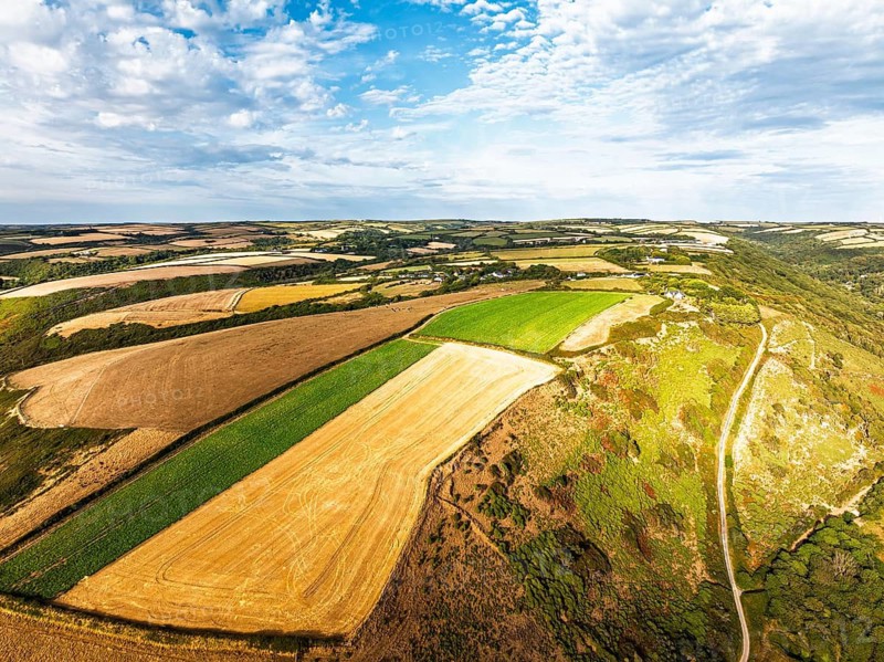 Cliffs and Farms over North Devon and Cornwall Coastpath Border from a drone, Welcombe Mouth Beach, Devon, Cornwall, England, Summer 2026