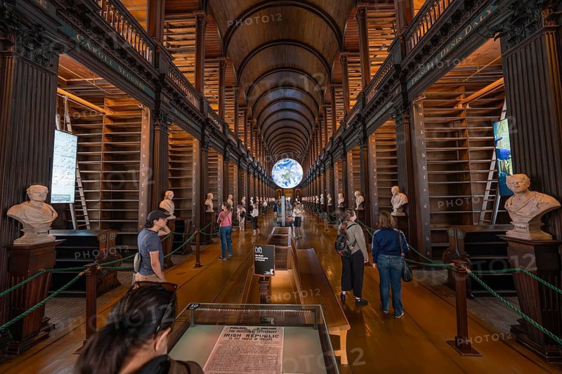 Long library hall with columns and busts, people looking at the surrounding area, Trinity Collage, Dublin, Ireland