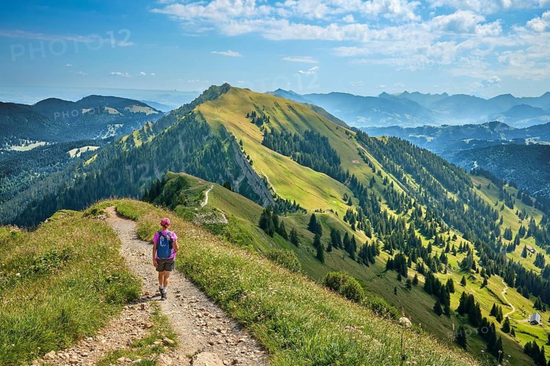 Active senior woman hiking along the picturesque ridge of the Nagelfluh Mountains in the Allgäu Alps, Oberstaufen Steibis, Allgäu, Bavaria, Germany