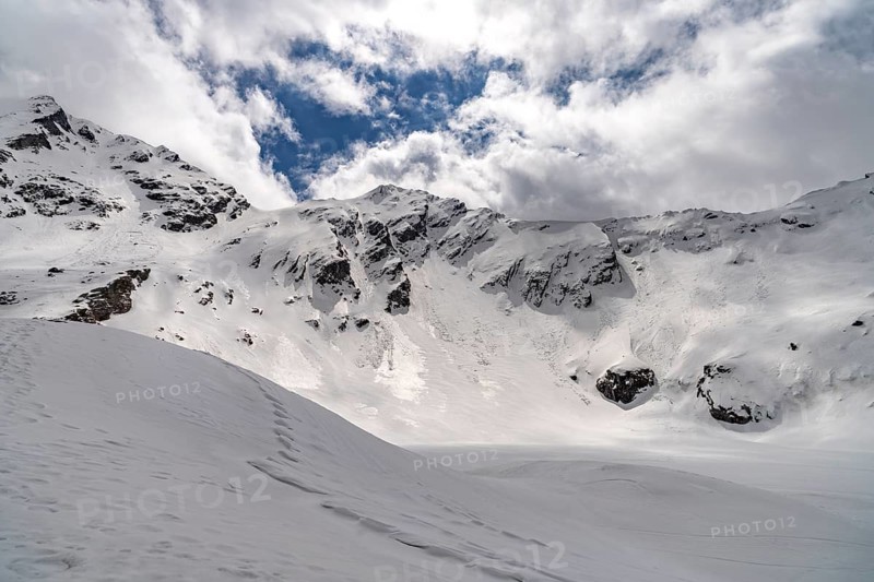 The snowy glacial lake Balea Lake in the Fagaras Mountains, South Carpathians, Transylvania, Romania