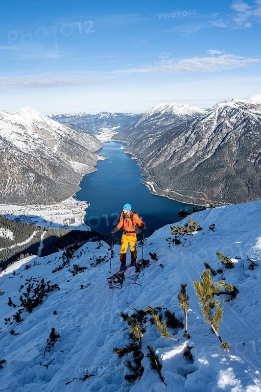 Picturesque view of Achensee and wintry mountain scenery, ski tourers climbing to Bärenkopf, Achensee, Tyrol, Austria