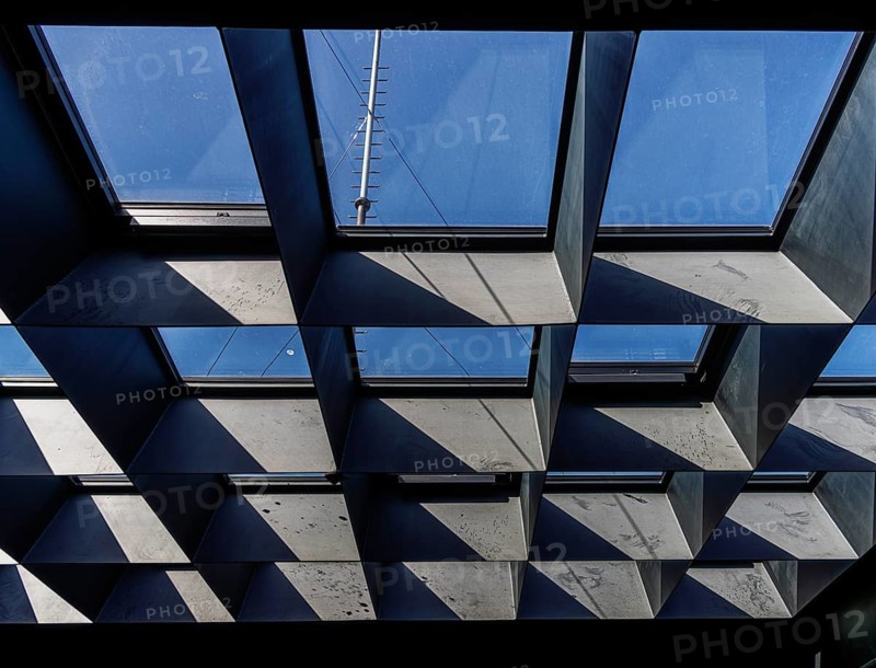 Geometric grid arrangement of skylight windows with deep metal or concrete reveals, Berlin, Germany