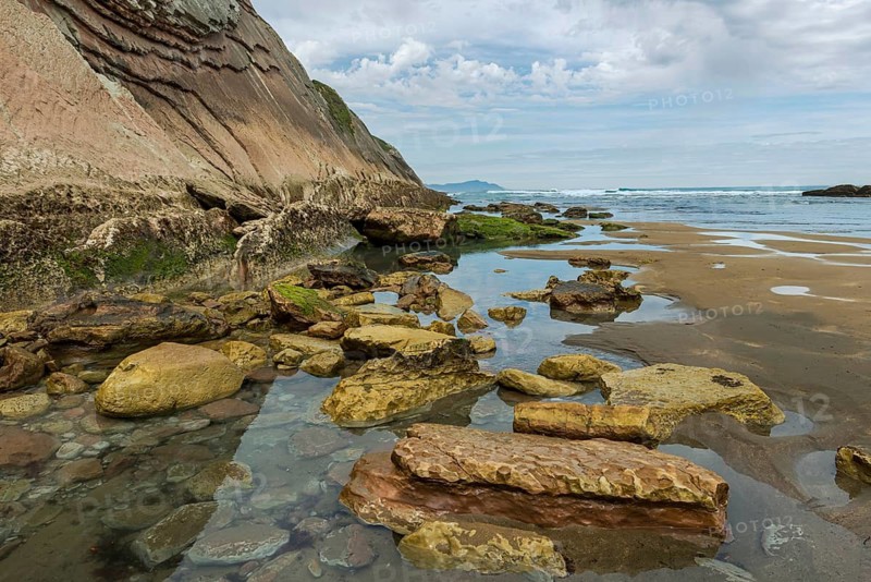 Distinctive rock cliffs as a geological formation of rock layers, Flysch on Itzurun Beach in Zumaia, Spain