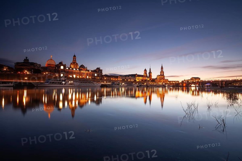 14 October 2021, illuminated historic skyline of Dresden reflected in the Elbe River at twilight, Dresden, Saxony, Germany