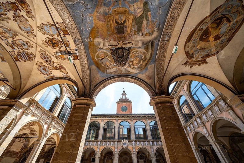 Arcades with ceiling paintings in the courtyard of the Palazzo dell'Archiginnasio, historic former university building, old town, Bologna, Emilia Romagna, Italy