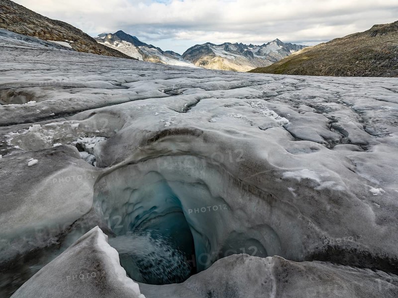 Glacier mill, glaciated mountains behind, Venedigerkees, Venice Group, Hohe Tauern National Park, Province of Salzburg, Austria
