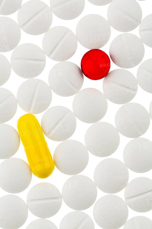 White and colorful tablets, symbolic photo for medicine, remedies and tablet addiction
