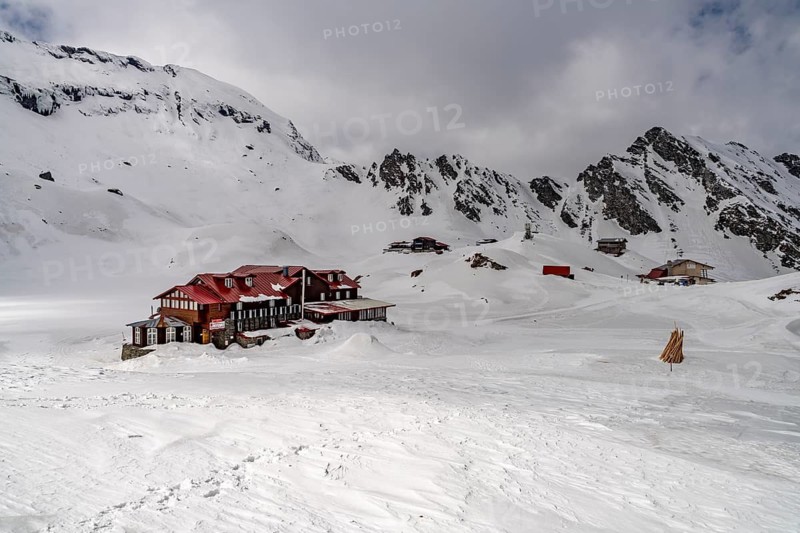 Mountain hut on snowy Balea Lake in the Fagaras Mountains, South Carpathians, Transylvania, Romania