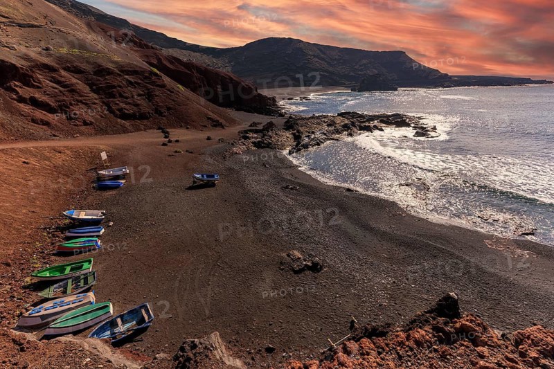 Lanzarote, Canary Islands, Spain, Europe, El Golfo, boats on dark coastal strip with dramatic sky in evening light