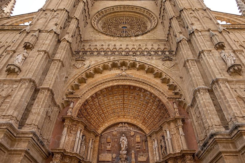 Palma Cathedral, also known as La Seu, is Palma's landmark and is one of the most important Gothic buildings in Europe. It was built from 1229 on the remains of a former mosque and impresses with its huge rose window and its location right by the sea. In the 20th century, Antoni Gaudí redesigned parts of the interior and gave the cathedral additional architectural accents, Palma, Majorca