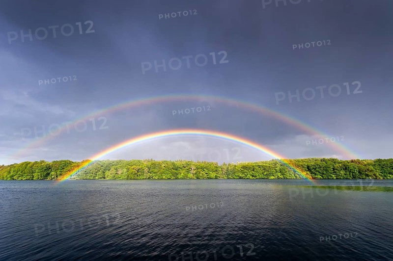 Colored rainbow over a lake, in Müritz National Park, Feldberger Seenlandschaft, Mecklenburg-Western Pomerania, Germany