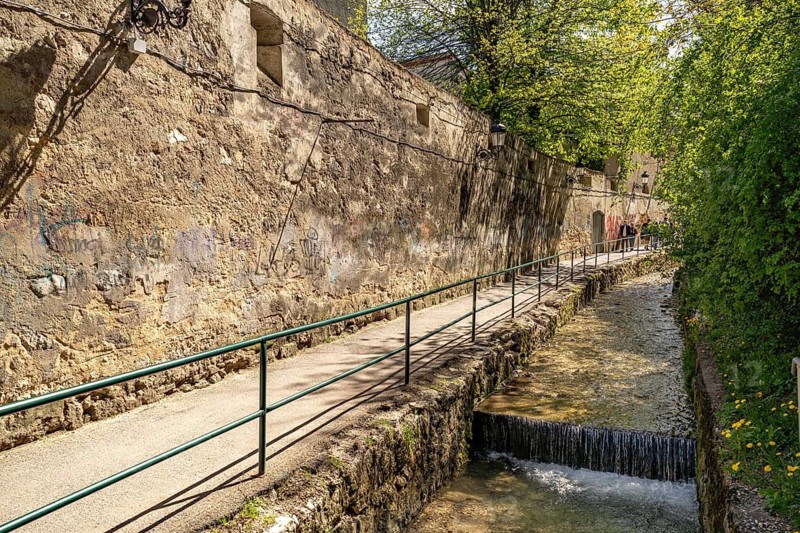 City wall and promenade on the Cheu river in Brasov or Kronstadt, Transylvania, Romania