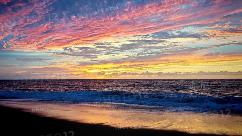 A colorful sunset over a quiet beach with gentle waves, Cabo Verde, Tarrafal de Monte Trigo, Santo Antao, Cape Verde, Cape Verde Islands