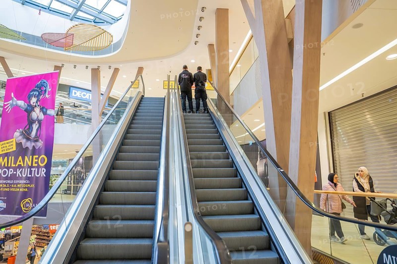 Interior view of a shopping center with escalator, surroundings and visitors, Milaneo, Stuttgart, Germany