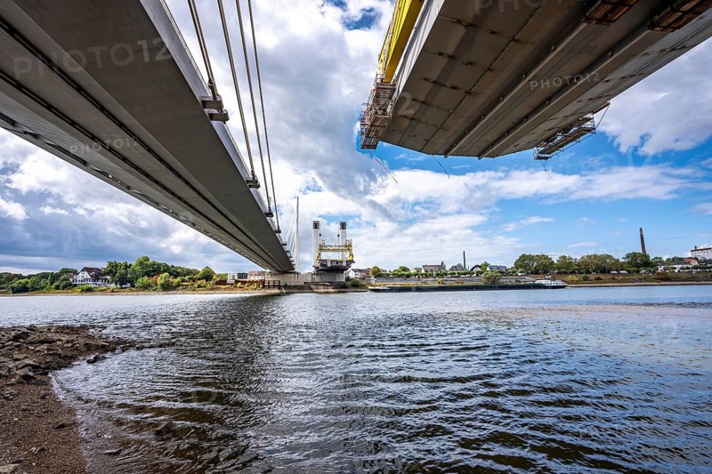 New construction of the second part of the Neuenkamp motorway bridge of the A40, across the Rhine near Duisburg, parallel to the existing first bridge, freighter on the Rhine, North Rhine-Westphalia, Germany