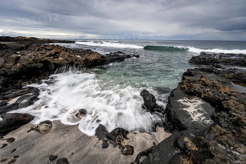 Waves blaze on the beach, rocky coast with volcanic stones, long exposure, Playa de la Pequeña, Punta Usaje, Lanzarote, Canary Islands, Spain