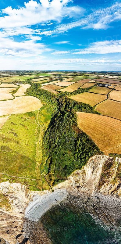 Cliffs and Farms over North Devon and Cornwall Coastpath Border from a drone, Welcombe Mouth Beach, Devon, Cornwall, England, Summer 2026
