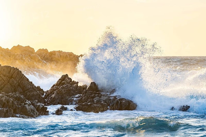 Braking waves at the coastline of Marinedda Coast at sunset, Sardinia, Italy