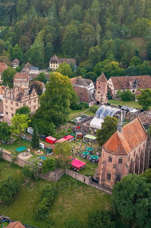 Festival tent with people and historic architecture in a wooded, hilly area, Calwer Klostersommer Festival, Hirsau Abbey, Calw, Black Forest, Germany