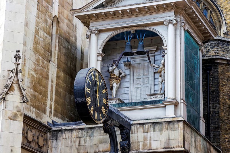 The projecting clock of St Dunstan-in-the-West stands out against the church tower and neighbouring red brick buildings on Fleet Street, its mechanism installed in 1671 after the Great Fire of London and long a celebrated landmark of the street. London, England, United Kingdom