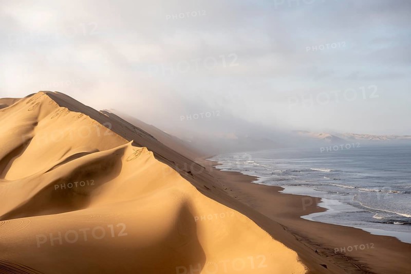 Sand dunes and sea, Atlantic coast and sandy desert with sea of dunes, Sandwich Harbour, Namib Naukluft Park, Namib Desert, Namibia