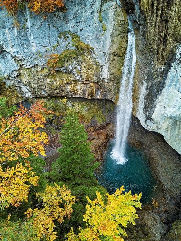 Aerial view of Berglistüber waterfall in autumn-colored surroundings, Linthal, Klausenpass, Canton of Glarus, Switzerland