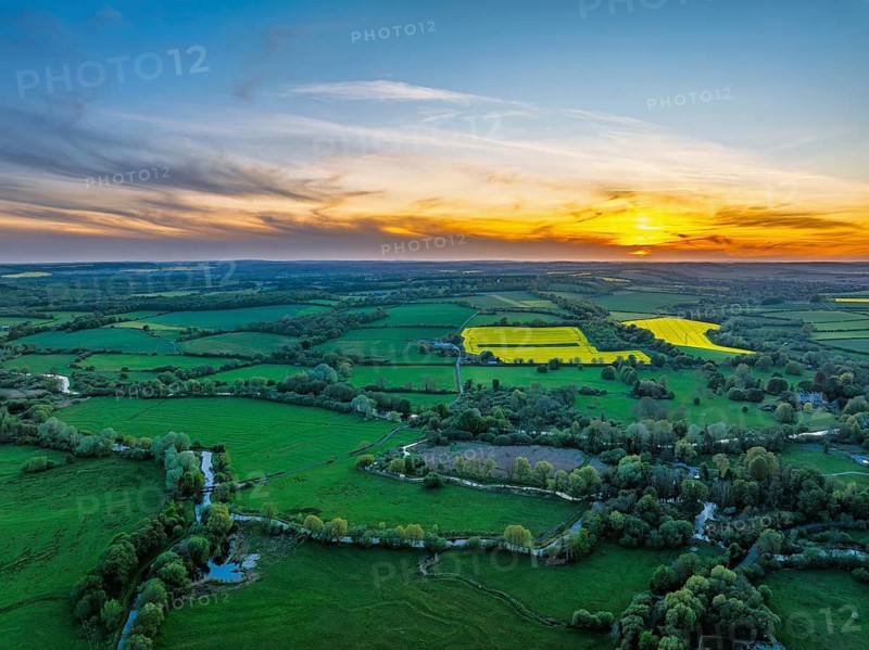 Sunset of Fields and Farms over Horsebridge nad Stockbridge from a drone, Hampshire, England, United Kingdom