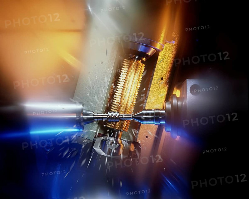 CNC controlled gear hobbing machine precisely machining a metal gear with cutting tool, flying chips and dramatic industrial lighting in modern manufacturing