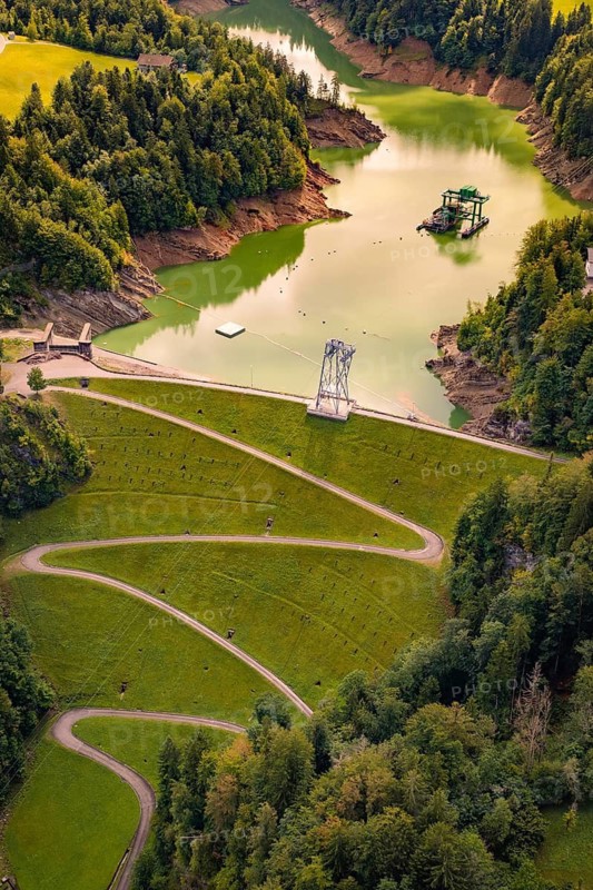 Idyllic river landscape with snake-shaped road and lush forest in a summery atmosphere, Krumbach, Vorarlberg, Austria