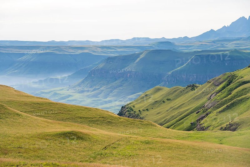 Green fields and mountains, cathedral range mountainous landscape, Drakensberg Mountains, KwaZulu-Natal, South Africa