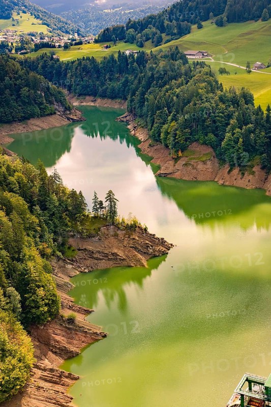 A quiet river snakes through thick forest and green hills, Krumbach, Vorarlberg, Austria