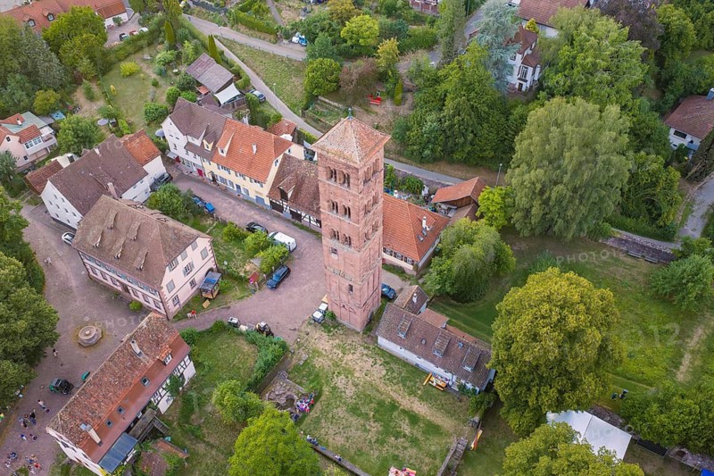 Rural scene with historic tower and half-timbered houses surrounded by green trees, Calwer Klostersommer Festival, Hirsau Abbey, Calw, Germany
