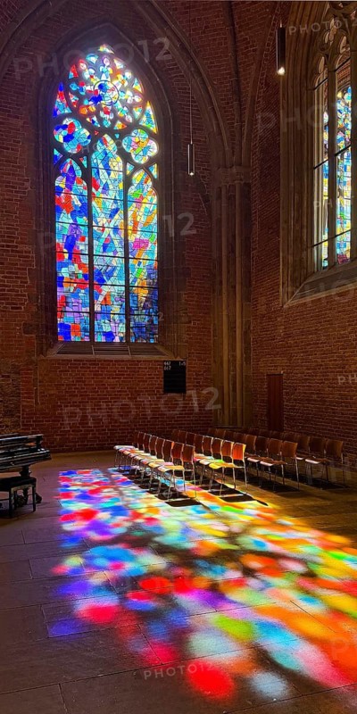 Stained glass window by Alfred Manessier with colorful light spots on the floor in the City Church of Our Dear Women, Hanseatic City of Bremen, Germany