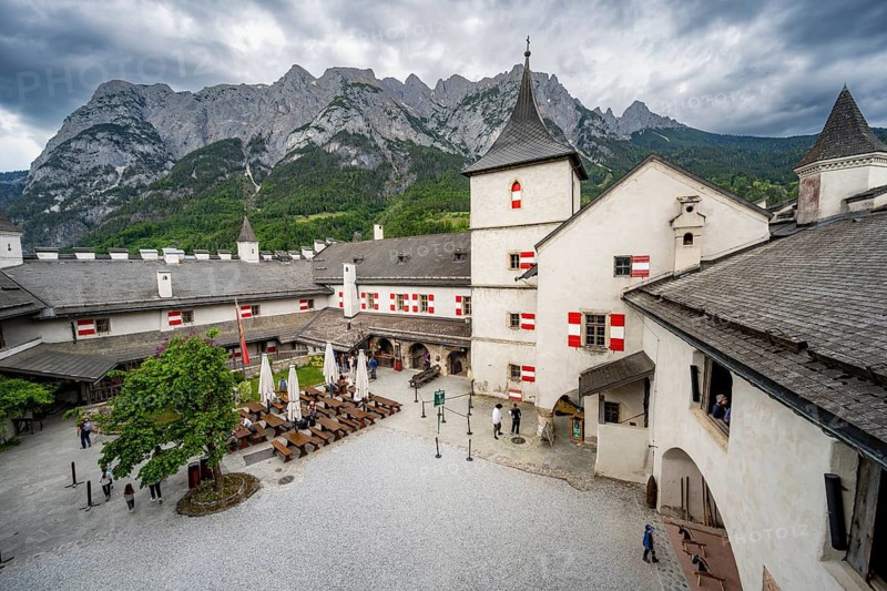 Castle with courtyard, mountain peaks of the Tennengebirge Mountains at the back, dramatic clouds, Hohenwerfen Fortress, Pongau, Salzburger Land, Austria