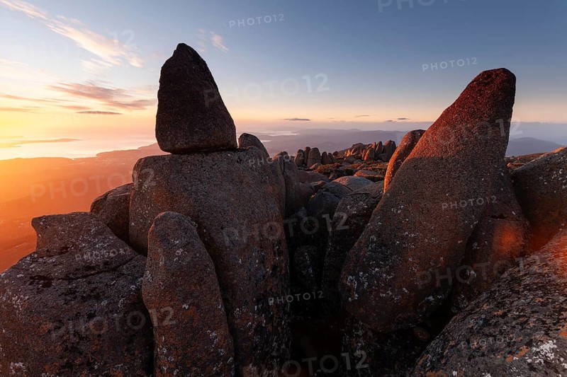 Glowing red sunrise over Mt. Wellington near Hobart. Sea of rocks on the summit