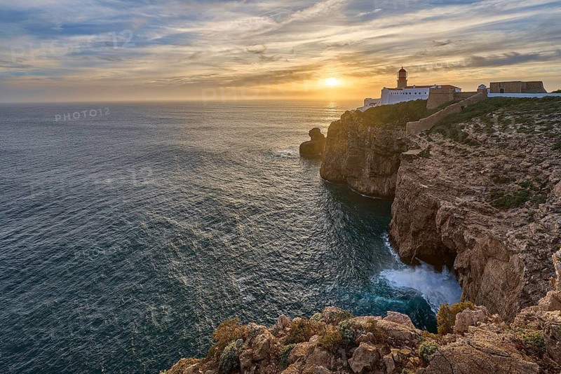 Moody view on Cabo Sao Vicente with its famous lighthouse at sunset at the south.estern spit of Europe near Sagres, Algarve, Portugal