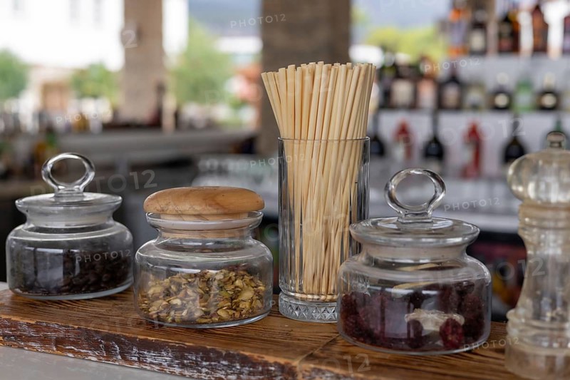 Straws are made from natural wheat and cane stems. They are totally biodegradable, compostable, zero-waste and plastic-free. Eco-friendly concept. The background reveals a modern cafe atmosphere