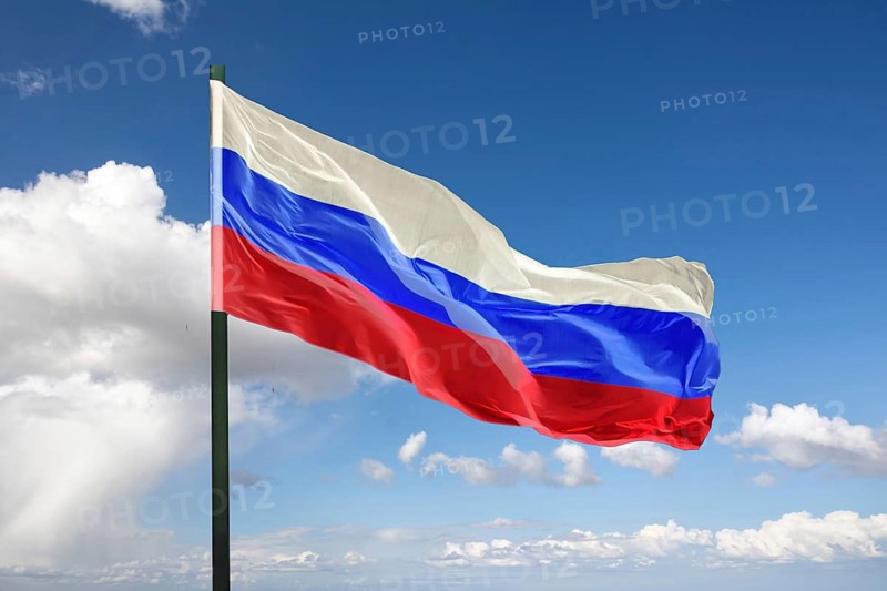 (Photo montage) Flag of Russia against blue sky
