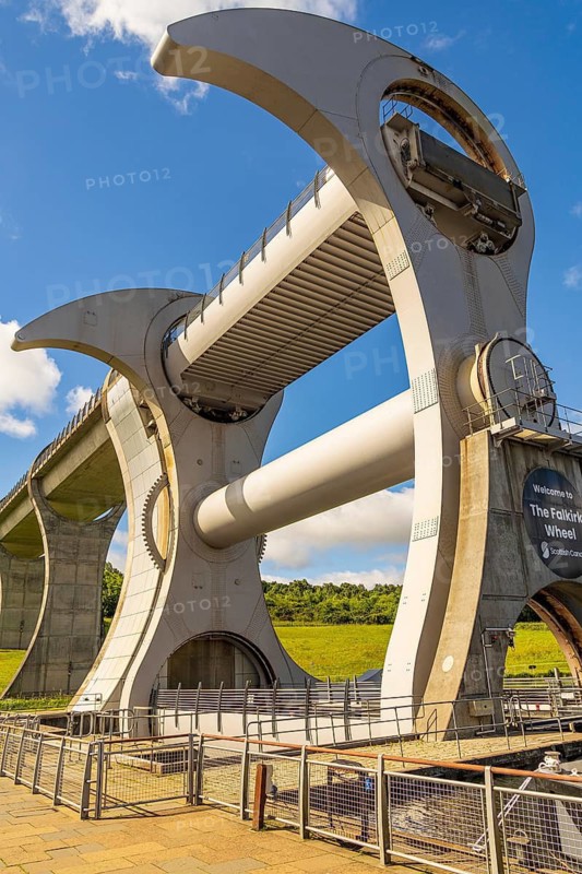 The Falkirk Wheel is the world's only rotating boat lift, connecting Scotland's Forth and Clyde Canal with the Union Canal. The wheel uses Archimedes' Principle to perfectly counterbalance two giant water-filled gondolas, allowing it to lift boats 24 metres in just five minutes, Tamfourhill, Falkirk, Scotland, United Kingdom