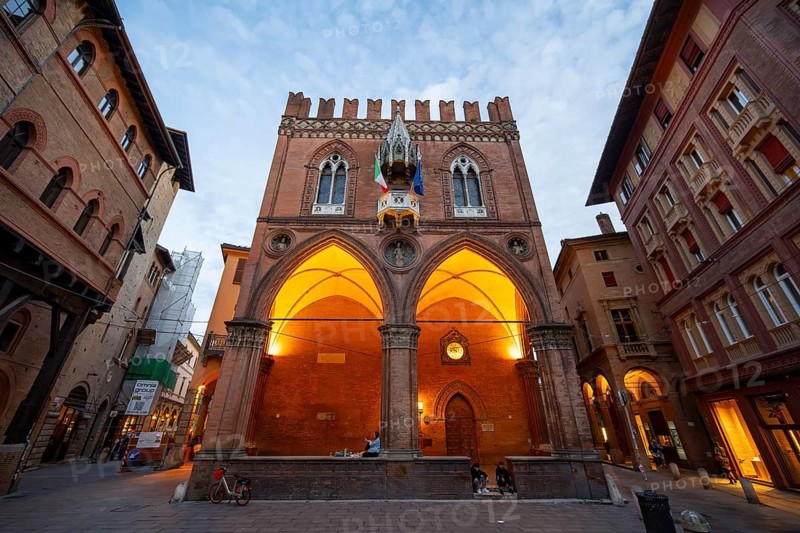Illuminated historic Palazzo della Mercanzia, old town, Bologna, Emilia Romagna, Italy