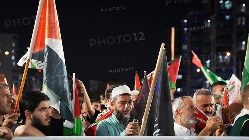 Gaziantep, Turkey - August 06, 2026: Participants of the Palestine Convoy, which set off from Sarajevo, Bosnia and Herzegovina, gather alongside local residents in Gaziantep while waving Palestinian flags to draw global attention to ongoing Israeli attacks on Gaza and the humanitarian crisis in Palestine, Gaziantep, Turkey